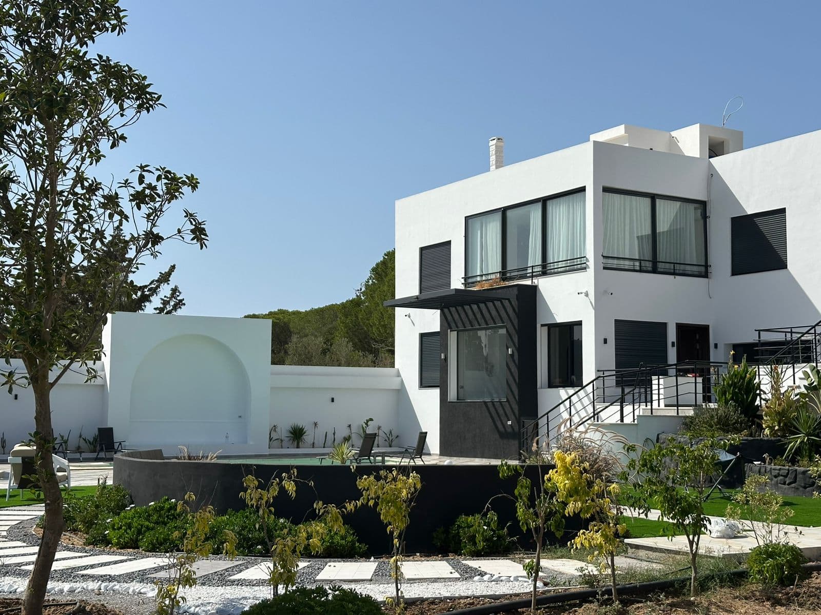 Pine-shaded gardens and pool at Pinaréa villa in Ras Jbal, Bizerte